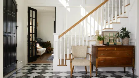 a staircase with a chair and a desk in front of it