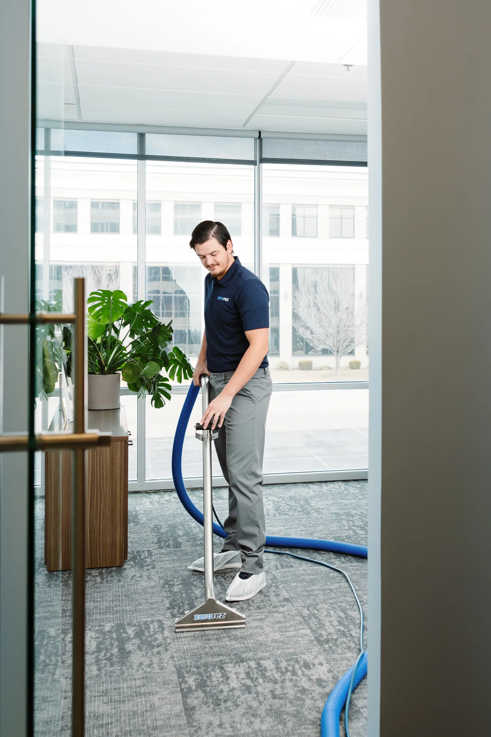 technician carpet cleaning in office