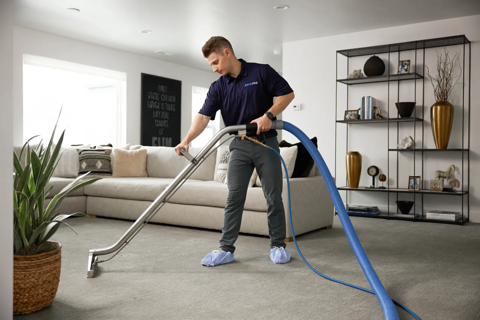 technician cleaning carpets in a living room