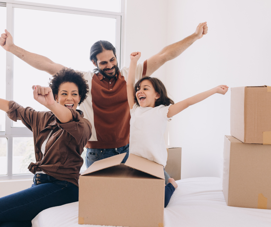 family moving into a new home with moving boxes